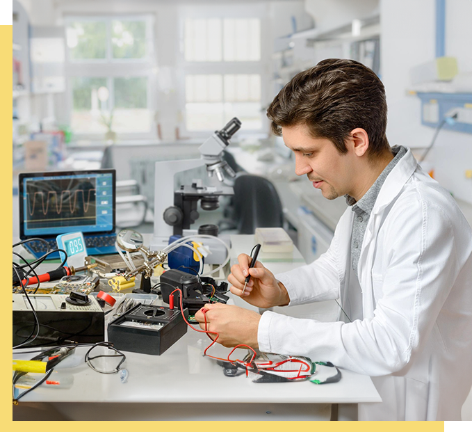 A man working on electronics in an office.